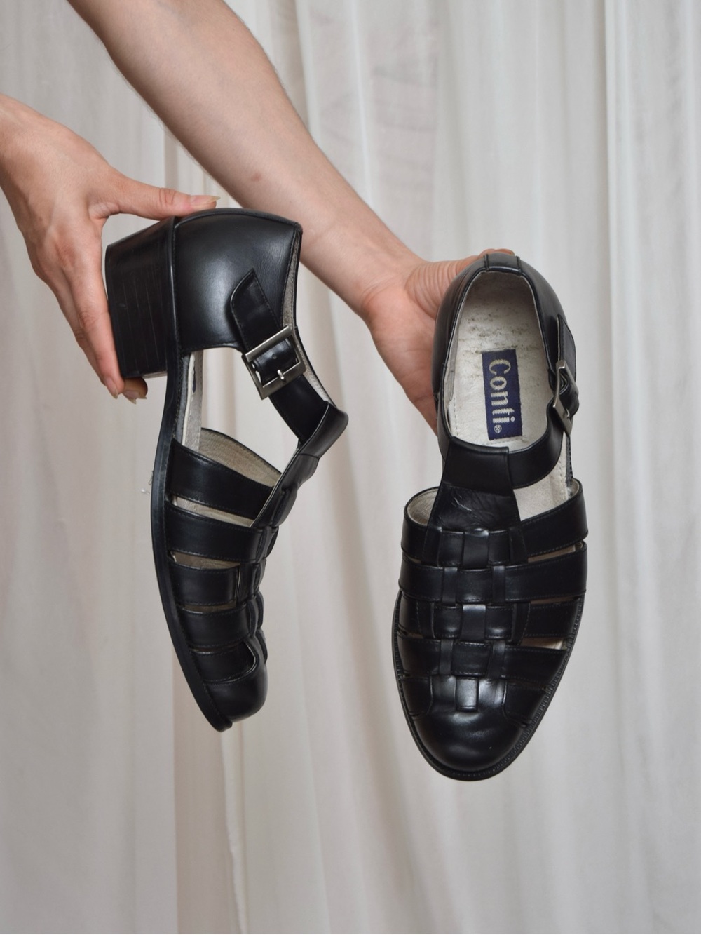 Black leather woven sandals / huaraches with buckle detail.